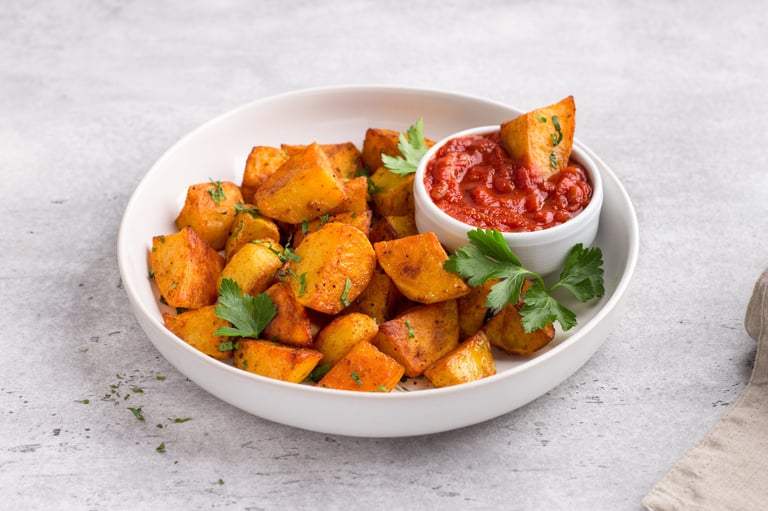 Patatas bravas with smoked paprika, spicy tomato sauce and parsley